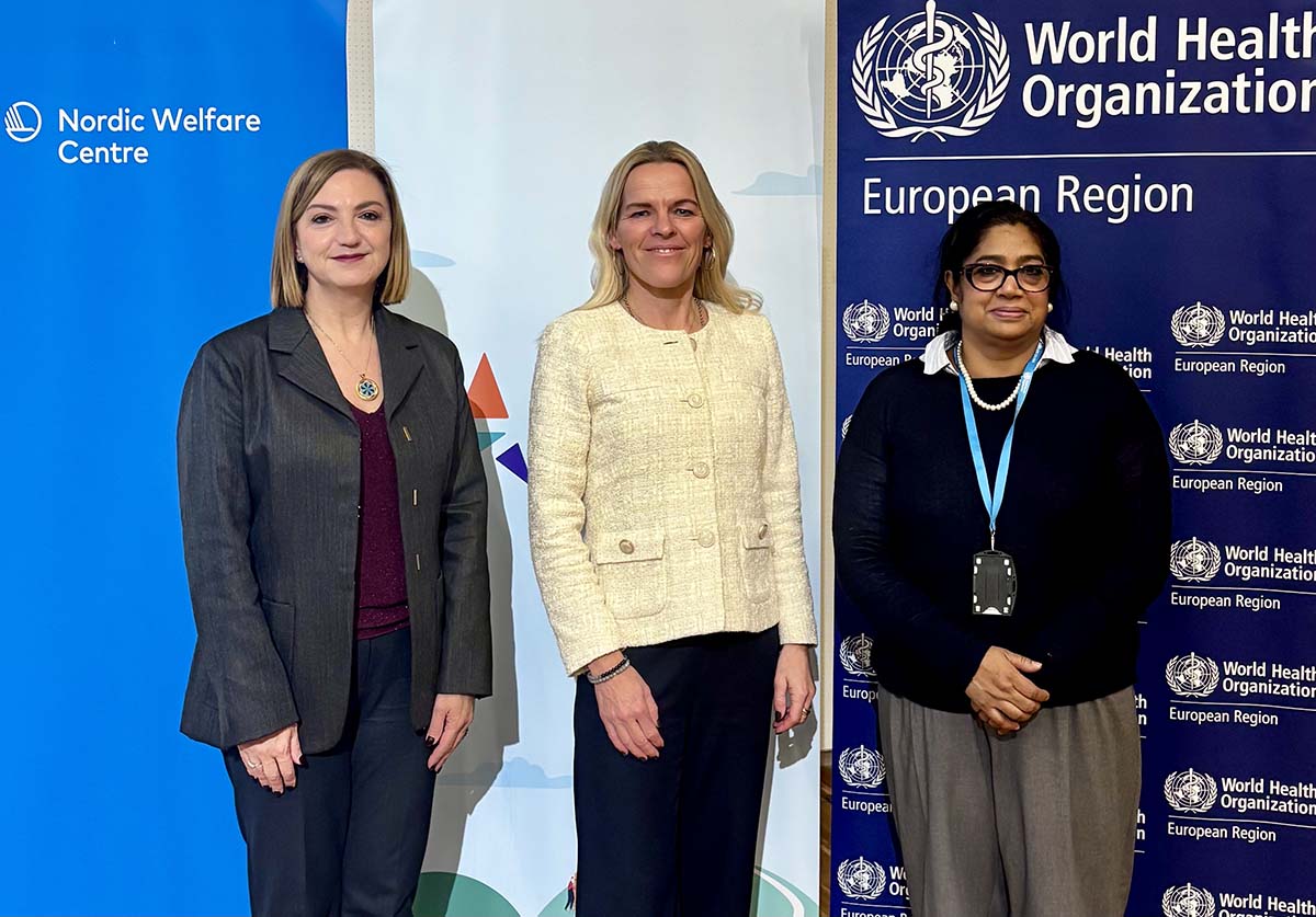 Three women standing side by side in front of Nordic Welfare Centre and WHO Europe banners. From left: Dr Natasha Azzopardi-Muscat, Mette Kierkgaard and Dr Chitralekha Marie Massey.