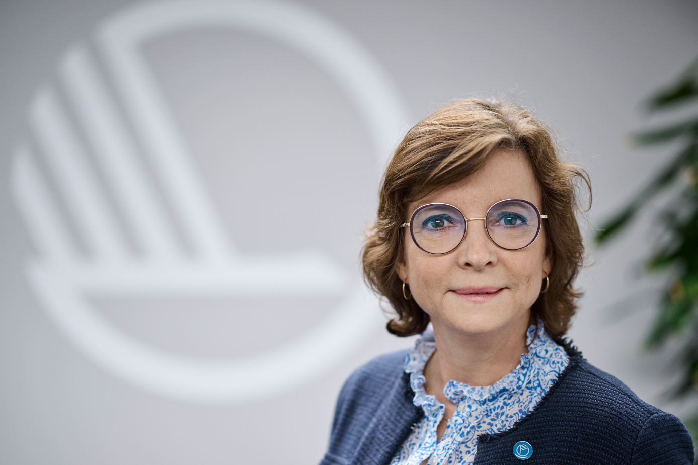 Portrait of Karen Elleman with the Nordic swan logo in the background