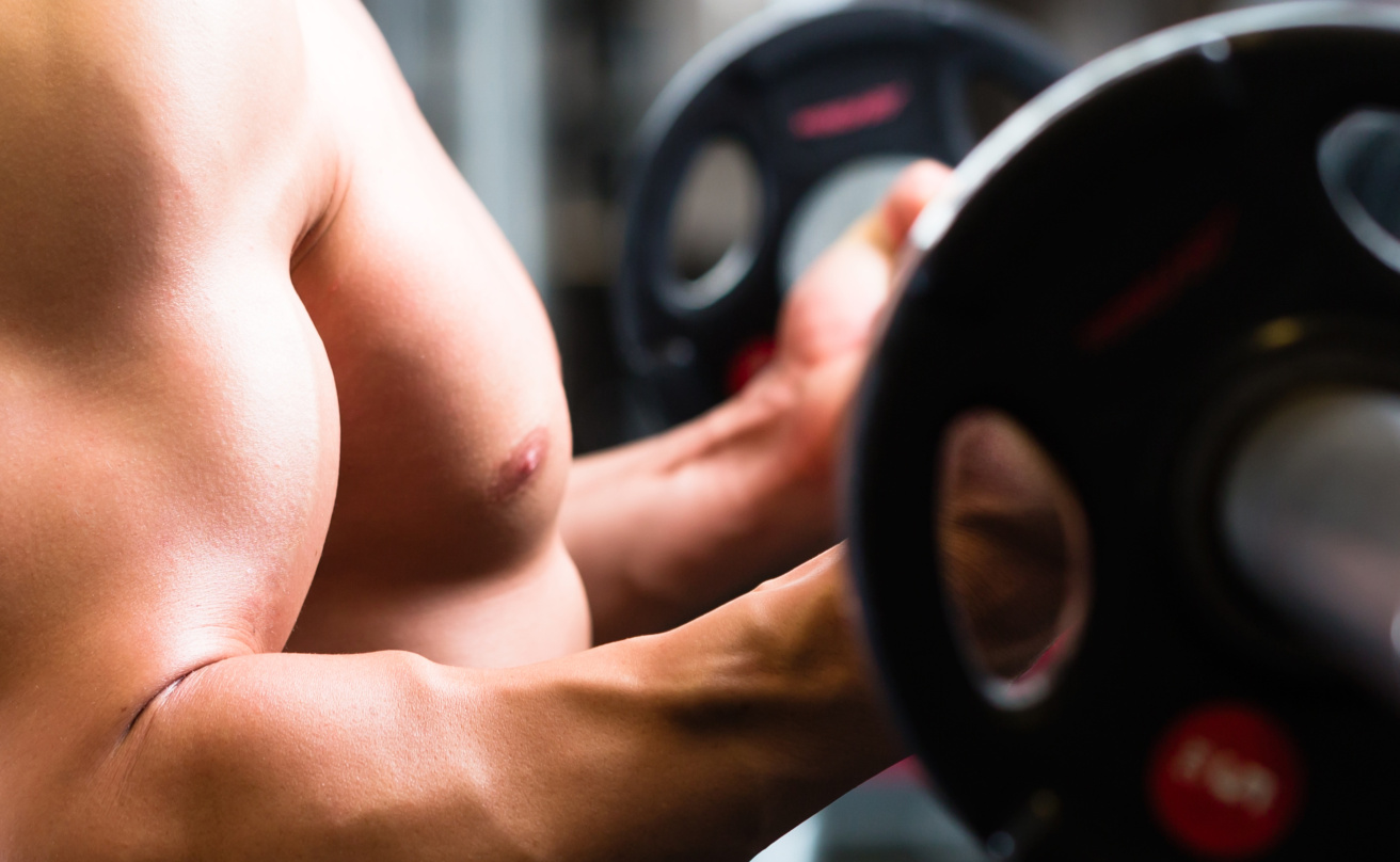 Man at Dumbbell training in gym