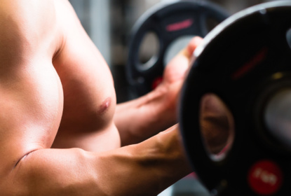 Man at Dumbbell training in gym