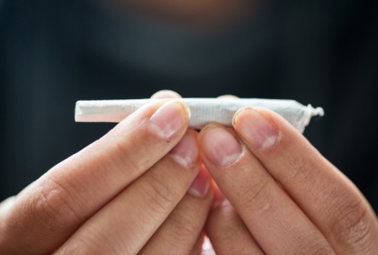 16893252-close-up-of-addict-hands-with-marijuana-joint