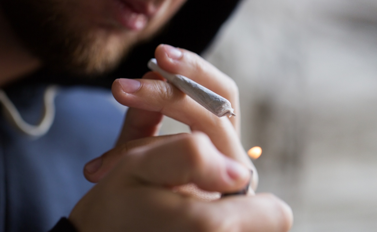 16893207-close-up-of-addict-lighting-up-marijuana-joint