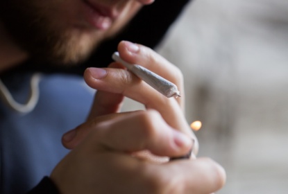 16893207-close-up-of-addict-lighting-up-marijuana-joint