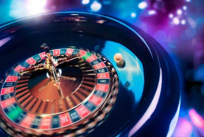 12823558-roulette-wheel-in-motion-with-a-bright-and-colorful-background