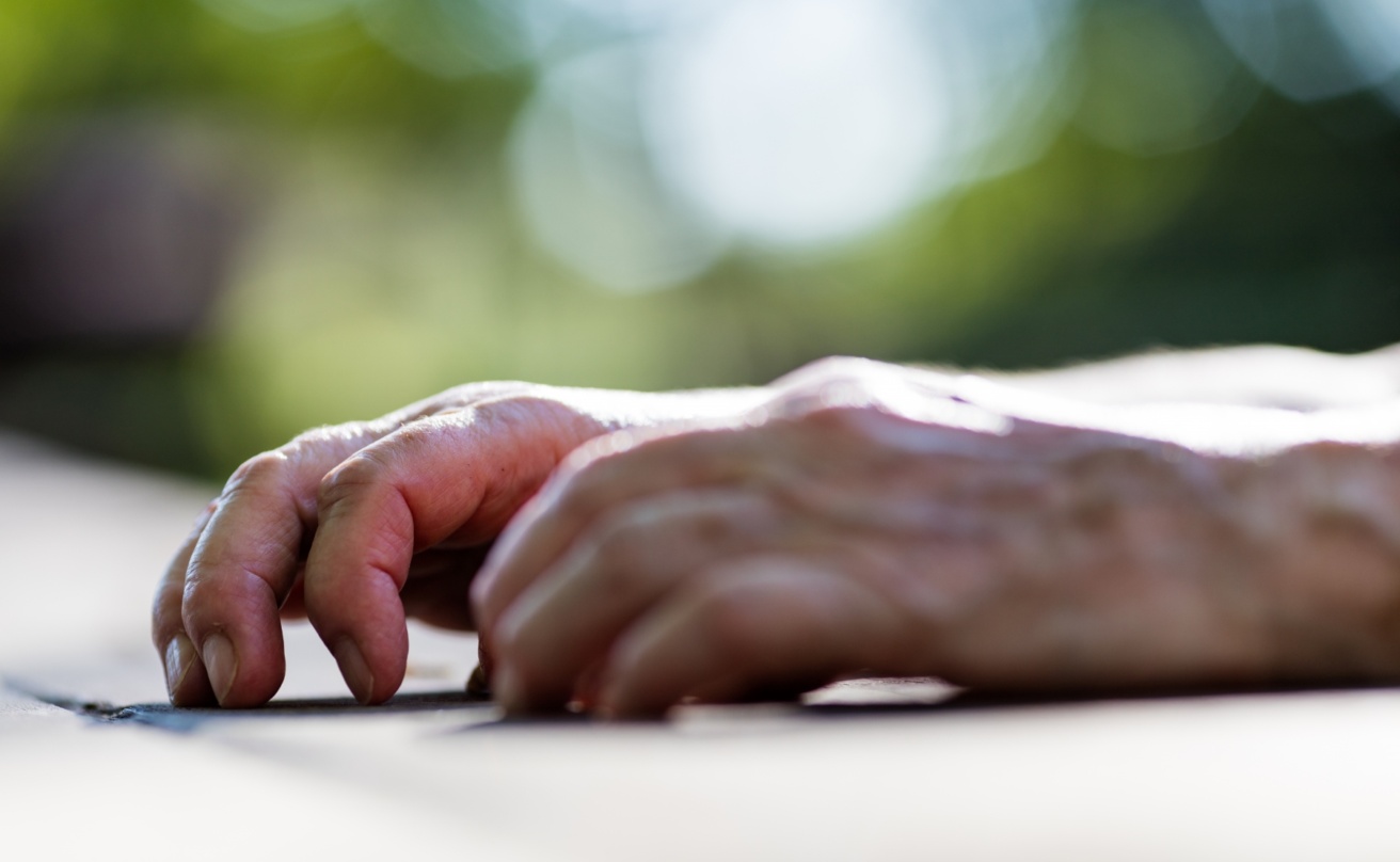 15638568-wrinkled-hands-of-an-old-woman-on-a-table
