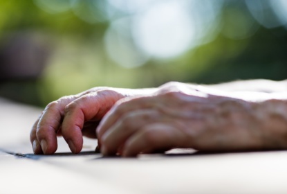 15638568-wrinkled-hands-of-an-old-woman-on-a-table