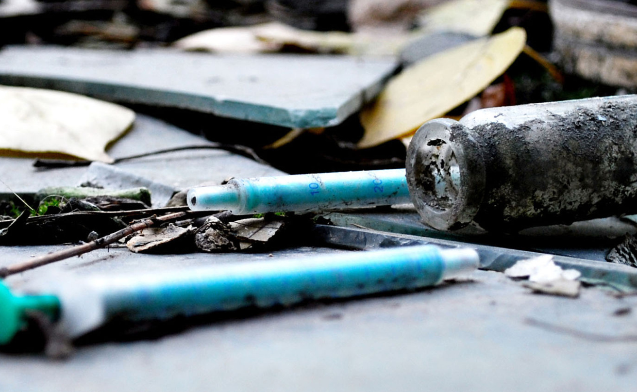 narcotic syringes in the junkyard amongst broken glass