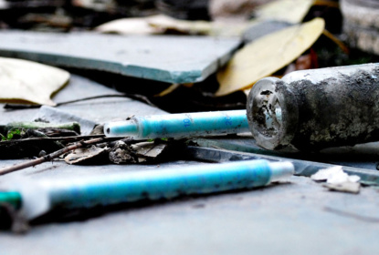 narcotic syringes in the junkyard amongst broken glass