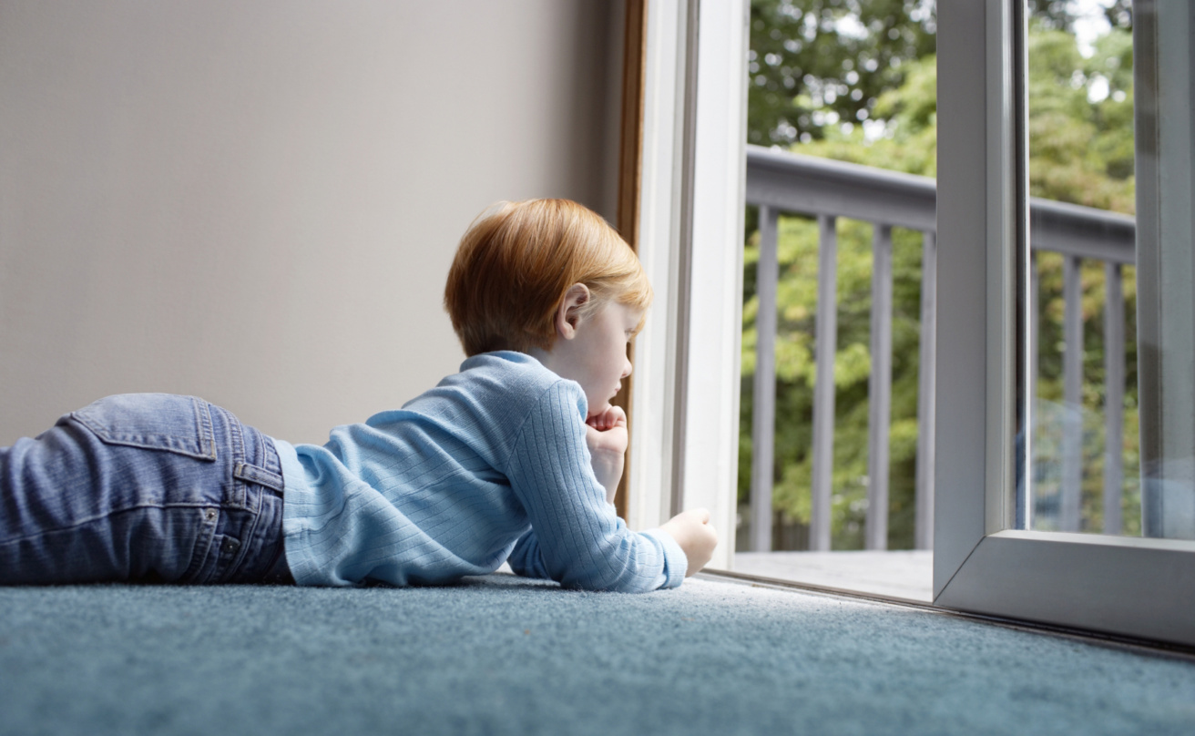 18812605-girl-looking-through-balcony-while-lying-on-carpet%20webb