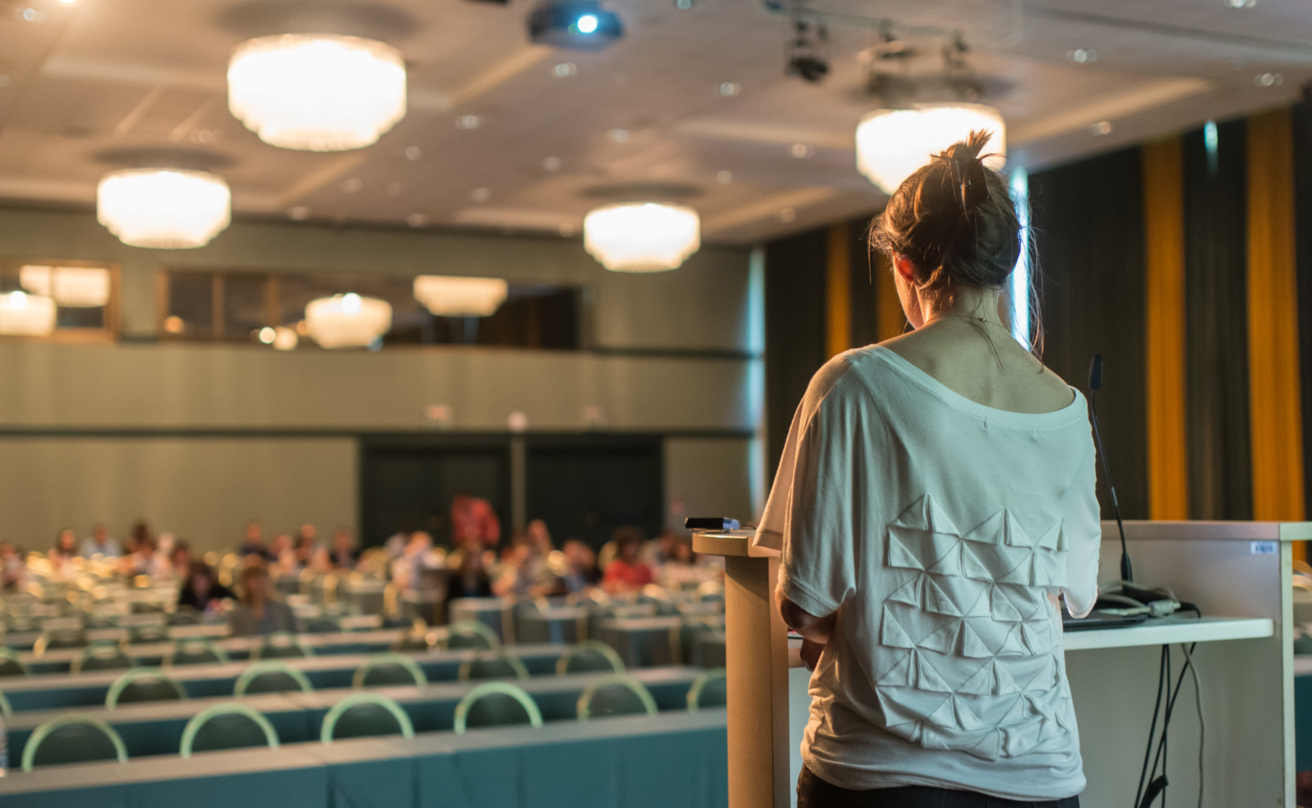 Public speaker giving talk at scientific conference.