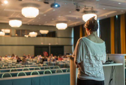 Public speaker giving talk at scientific conference.