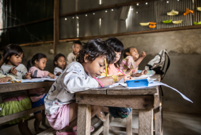 Siem Reap, Cambodia - Jan 22, 2014: Local students having English lessons at their school. The school named New Bridge for Cambodia is a organization that offers students free education. Students whose families are not rich can get free lessons on fundamental curriculums. The school also relies on international aid from organizations like AIESEC. Photo: Yongyuan Dai
