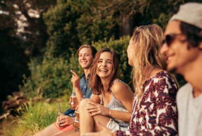 Cheerful young friends hanging out with beers