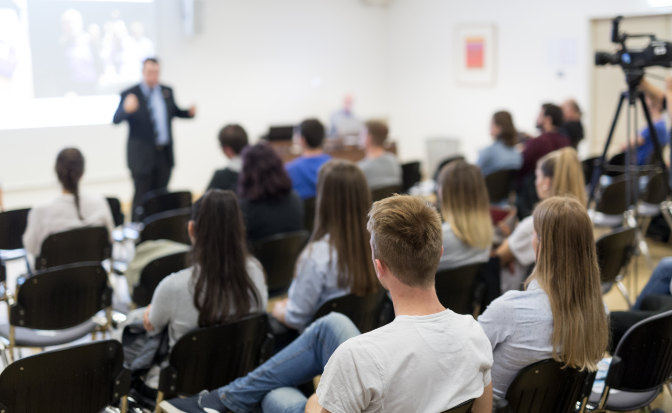 Professor lecturing in lecture hall at university.