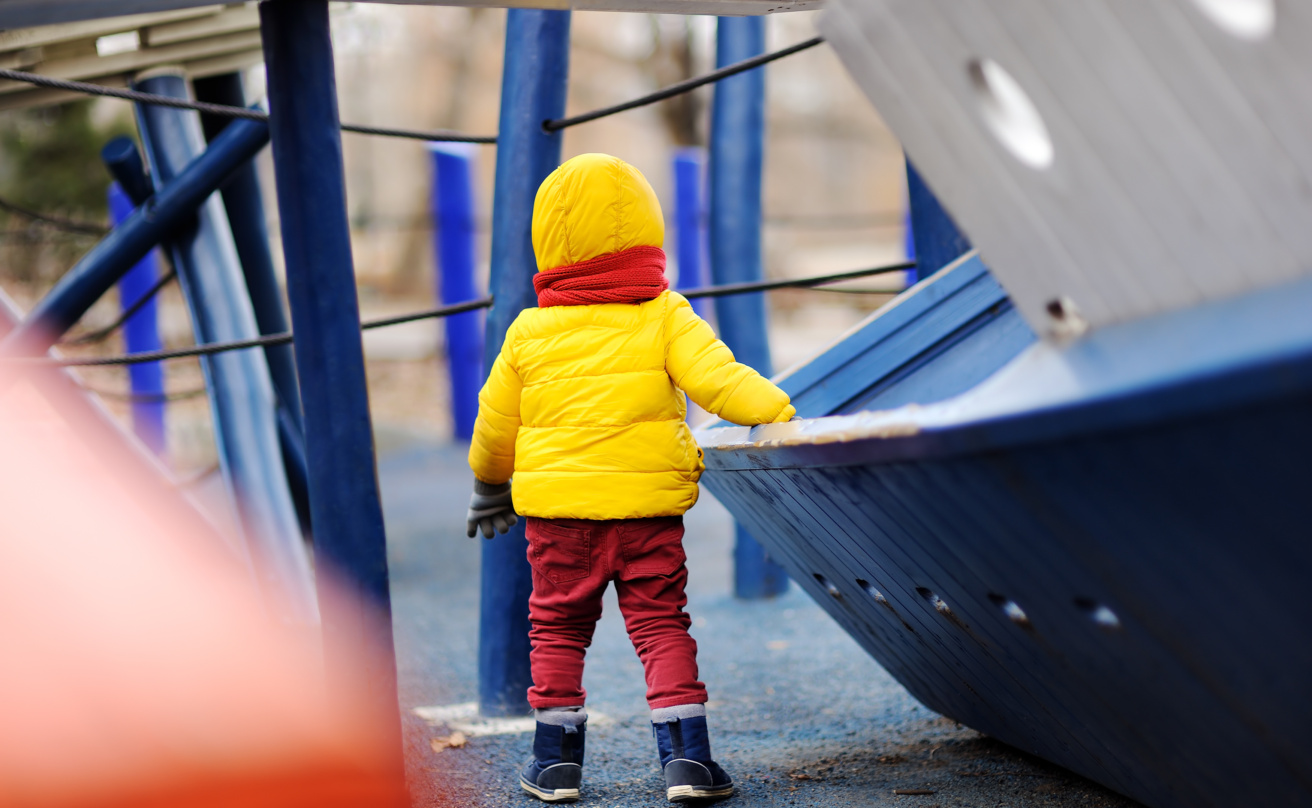 Cute little boy having fun on outdoor playground