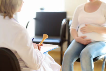 Gynecologist doctor accepts of a pregnant woman. Medical insurance childbearing. Family doctor for gestation. Maternity leave.