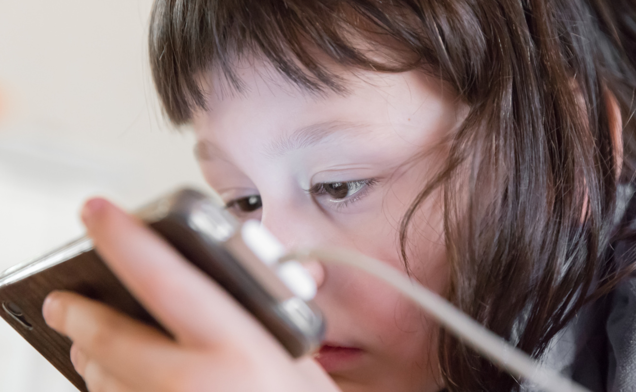 Little girl watching a smartphone