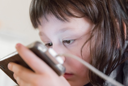 Little girl watching a smartphone