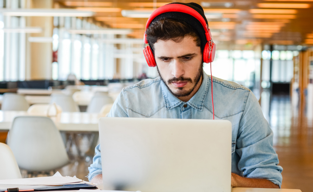 Young male student studying at university campus.