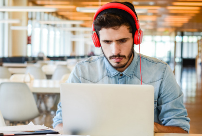 Young male student studying at university campus.