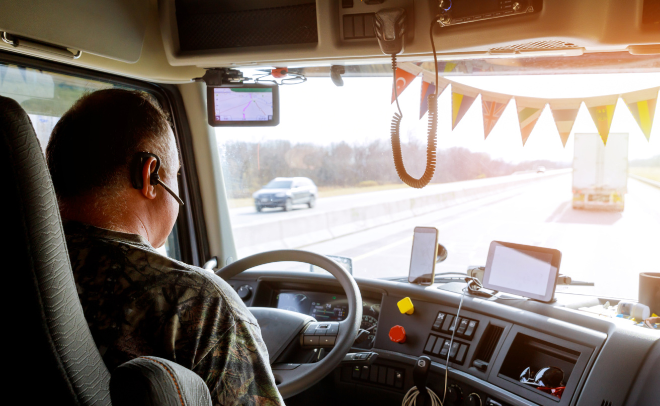 Driver in cabin of big modern truck