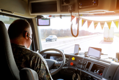 Driver in cabin of big modern truck