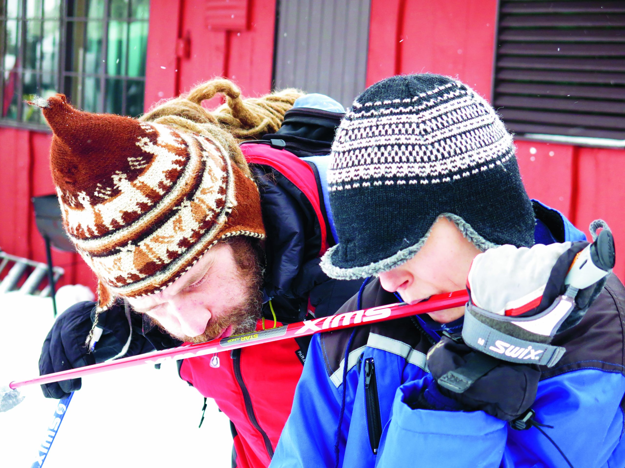 Joe Gibson and a boy tactily explore a skiing pole. 
