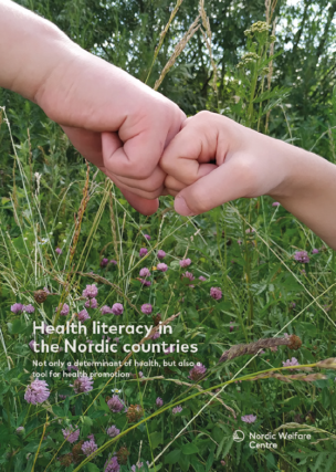 The hand of a child and the hand of an adult fist bumping among flowers.
