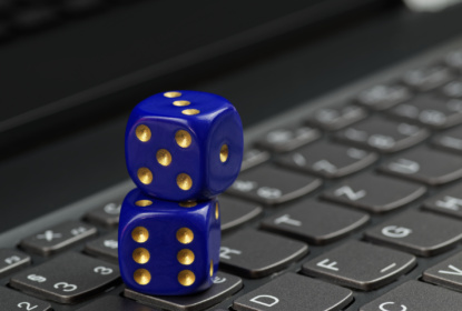 35708003-two-blue-dices-on-black-computer-keyboard