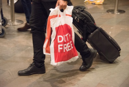 Man carrying duty free bags