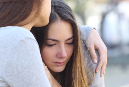 11648559-sad-girl-crying-and-a-friend-comforting-her