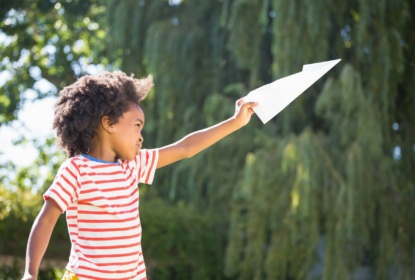 15645718-boy-is-playing-with-a-paper-plane