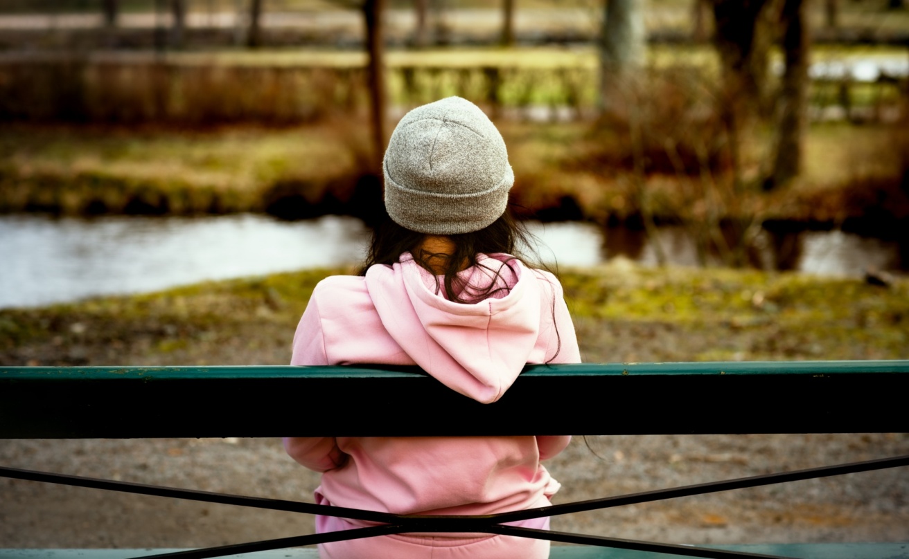 61810096-woman-sitting-alone-on-park-bench