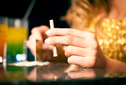 Young woman snorting cocaine