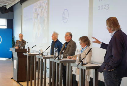 Panel discussion with four participants and a moderator.