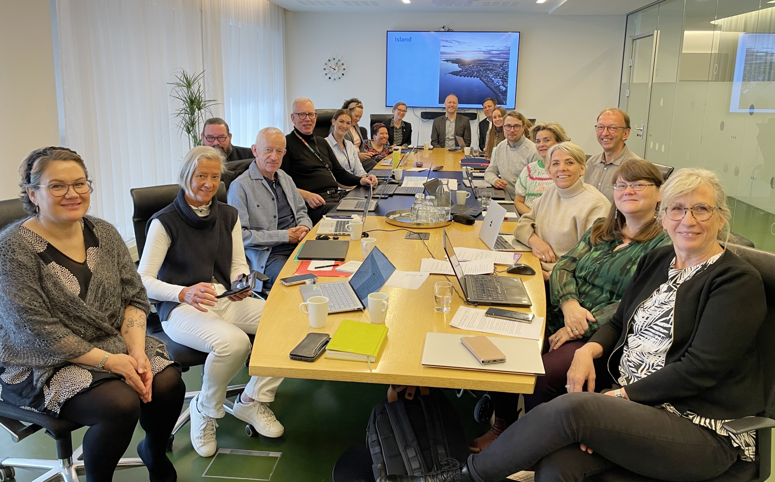 A group of people sitting around a conference table, meeting at the ministry