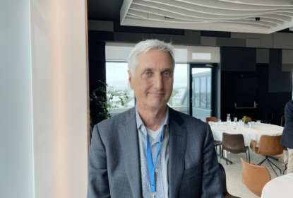 Portrait of Anton Hemerijc standing inside a conference room.
