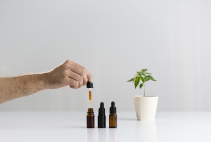 31274226-hand-dropping-cbd-oil-from-pipette-to-the-bottle