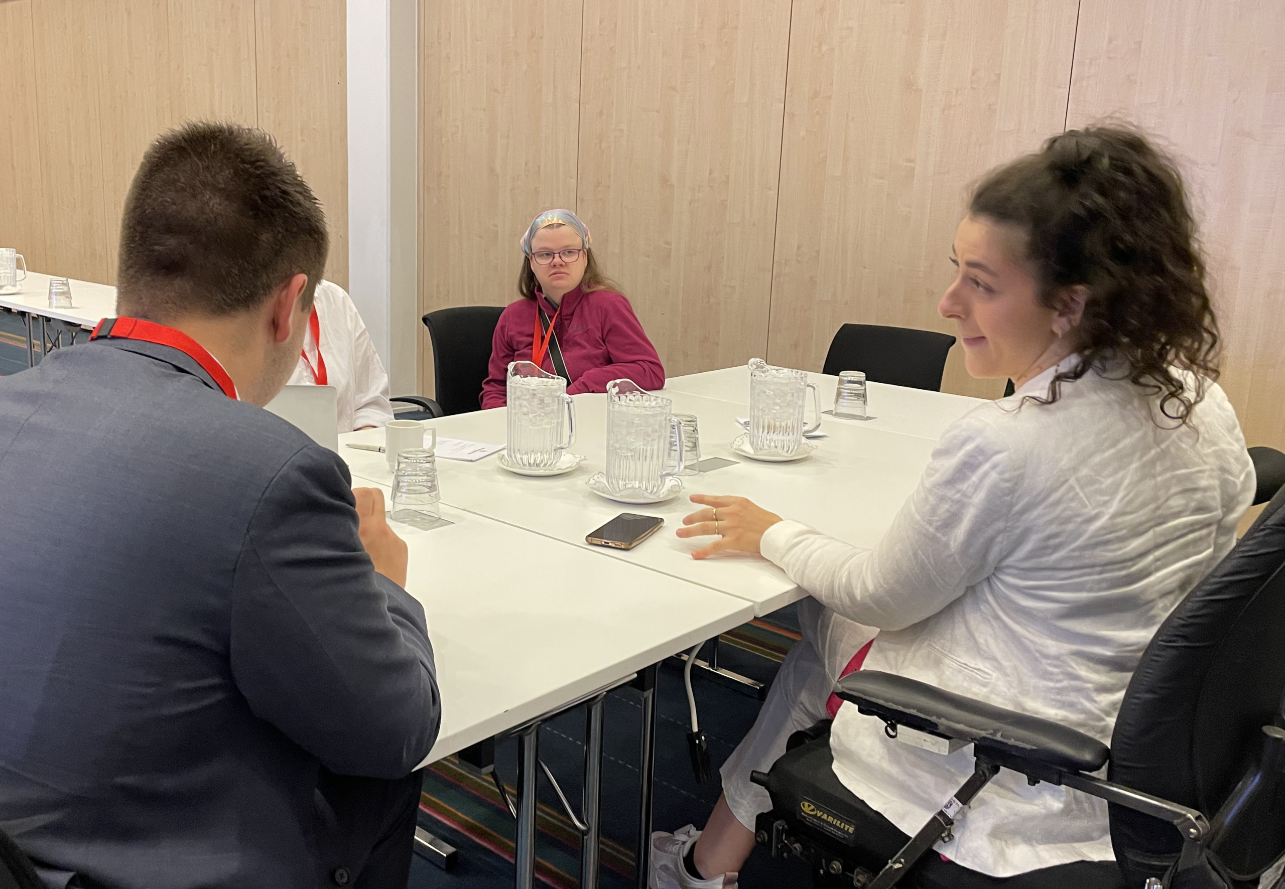 3 people sitting around a table discussing