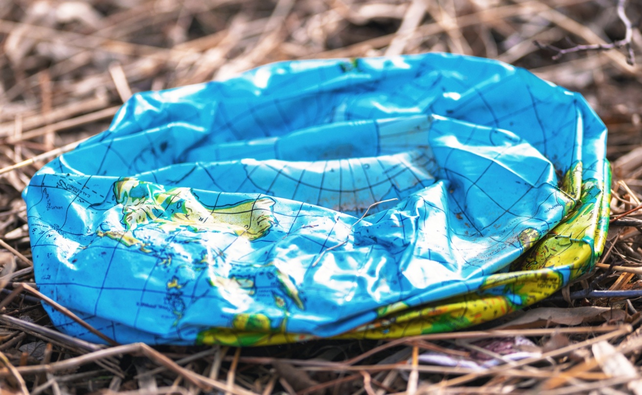 Plastic deflated earth thrown in nature