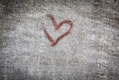 Red heart painting on a grungy wall