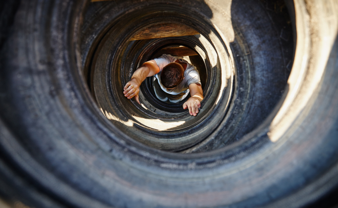 Picture from above of man climbing up a tunnel