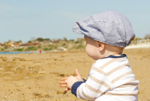 Toddler sitting on beach