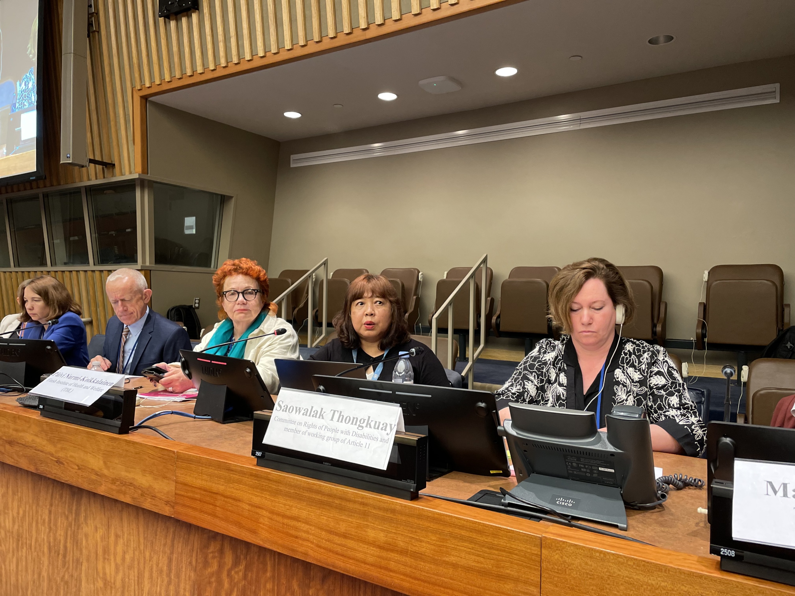 Saowalak Thongkuay speaking at the Nordic side event. Two women sitting on each side of her at a conference podium.