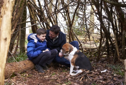 father-and-son-talking-under-a-shelter-of-branches-with