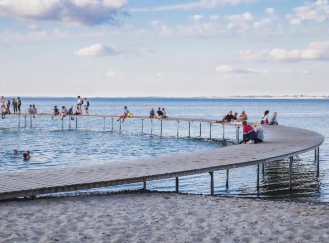 people-rest-on-a-round-pier-in-denmark