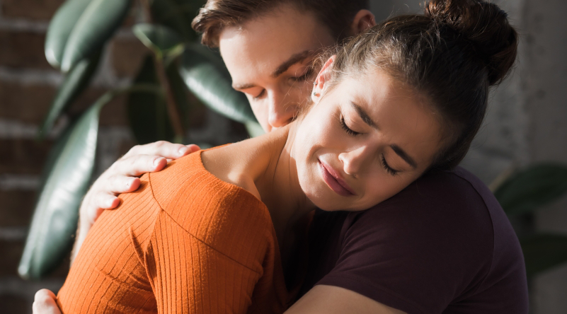 Woman crying being hugged by man showing self-regulation