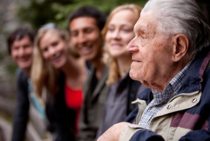 Older man with younger people in the background