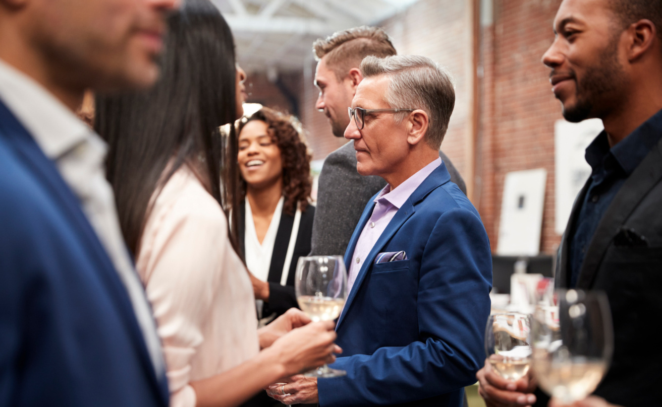 mp31205386-business-team-socializing-at-after-works-drinks-in-modern-office