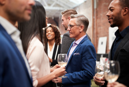 mp31205386-business-team-socializing-at-after-works-drinks-in-modern-office